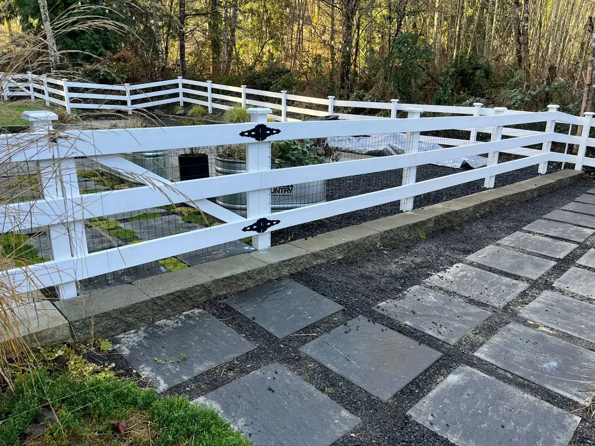 White fence and stone pavers