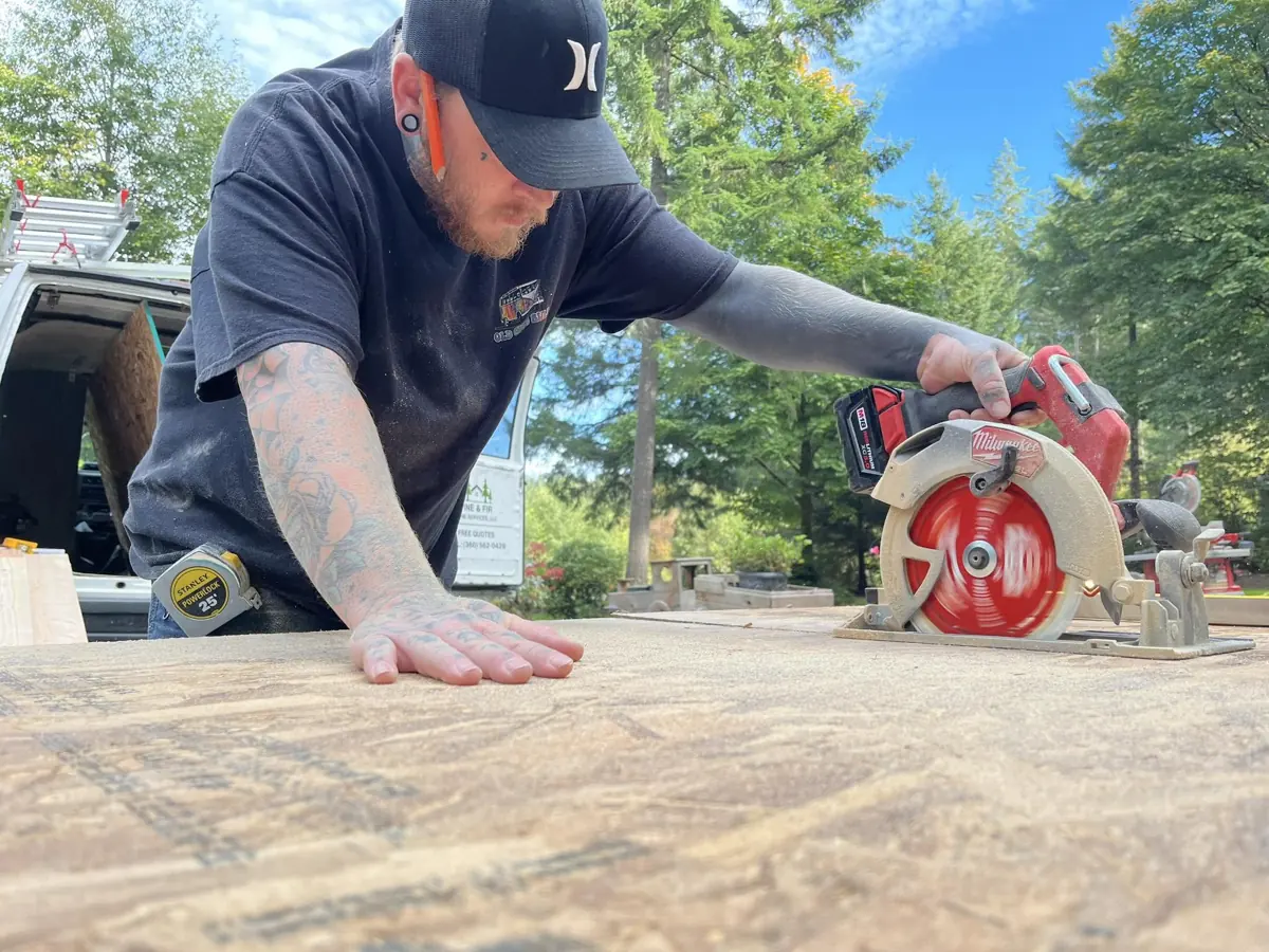 Blake cutting lumber with a circular saw
